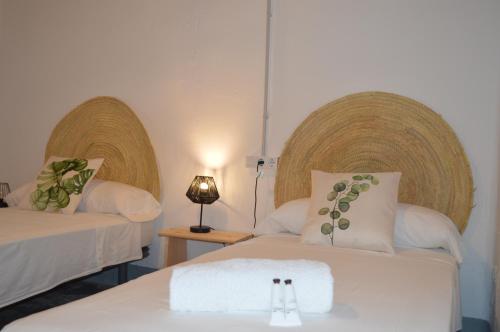 a room with two beds with towels on them at MASIA ESTORACH in L'Aldea