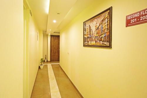 a hallway with a painting hanging on a wall at Mayda Inn- A Boutique Hotel in New Delhi