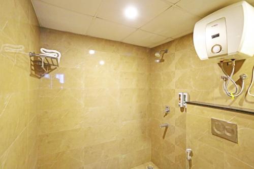 a bathroom with a shower with a toilet and a shower at Mayda Inn- A Boutique Hotel in New Delhi