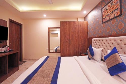 a bedroom with a large bed and a mirror at Mayda Inn- A Boutique Hotel in New Delhi