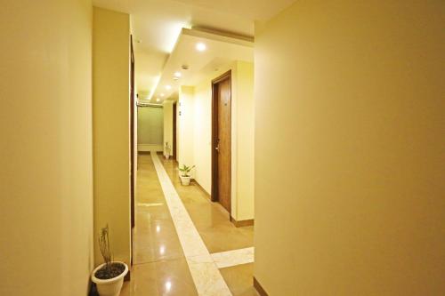 a hallway with a toilet and a potted plant at Mayda Inn- A Boutique Hotel in New Delhi