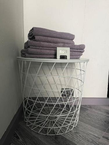 a wire basket with towels on top of a shelf at Dzīvoklis ar skatu pār Alūksni in Alūksne