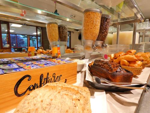 a bakery with bread and pastries on a table at Hôtel du Parc Limoges & Restaurant "Le temps d'une pause" in Limoges
