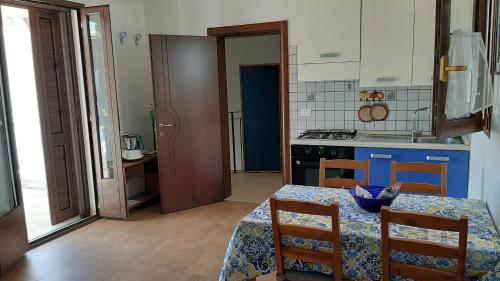 a kitchen with a table and a stove top oven at Casa Giulia in Tiggiano