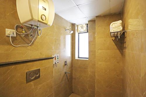 a bathroom with a shower with a window and a sink at Mayda Inn- A Boutique Hotel in New Delhi