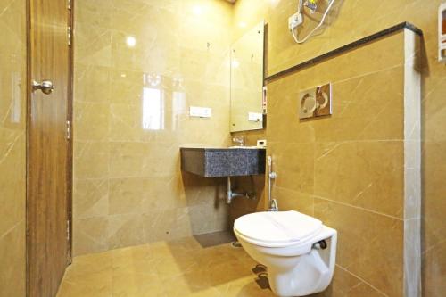 a bathroom with a toilet and a shower at Mayda Inn- A Boutique Hotel in New Delhi