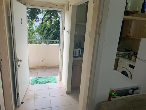 an open door to a kitchen with a tile floor at משמר הגבול 9 דירה 4 in Haifa