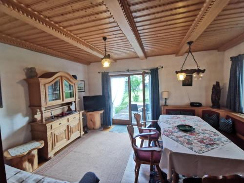 a living room with a table and chairs and a room at Haus Luise in Krün