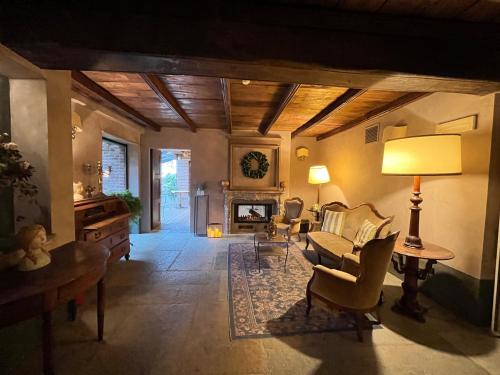a living room with a couch and a fireplace at Locanda Maison Verte in Cantalupa