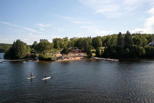 two people on paddle boards in the water at Station Touristique Duchesnay - Sepaq in Sainte-Catherine