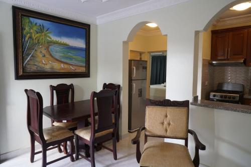 a kitchen and dining room with a table and chairs at Villa Gumio 2BR Apt- 7 min walk to Boca Chica Beach apts in Boca Chica