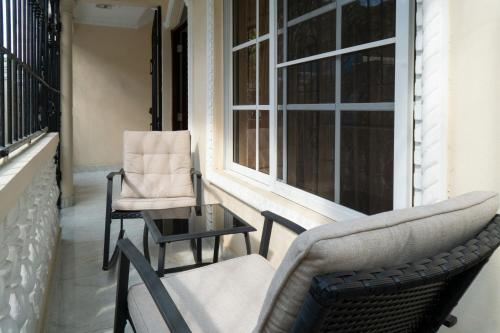 a pair of chairs and a table on a porch at Villa Gumio 2BR Apt- 7 min walk to Boca Chica Beach apts in Boca Chica