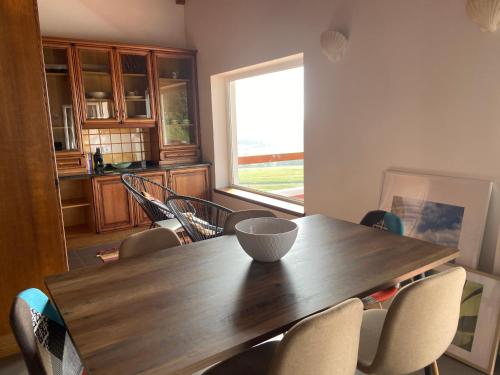 a dining room with a wooden table and chairs at casa panorâmica bela vista in Angra do Heroísmo