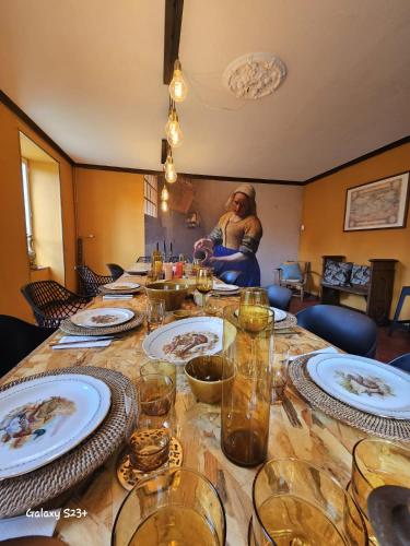 a long table with plates and glasses on it at Moulin en Route in Blèves