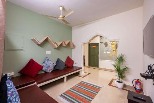 a living room with a couch and a green door at Zostel Kochi, Fort Kochi in Cochin