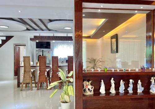 a room with a bar with chairs and a table at Cheryl's Place Vacation Home Palawan in Puerto Princesa City