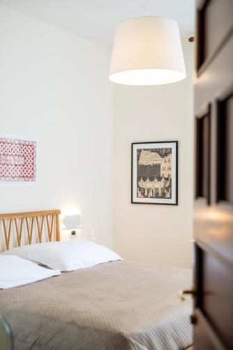 a bedroom with a bed with a lamp on it at B&B Marcantonio - Ischia Ponte in Ischia
