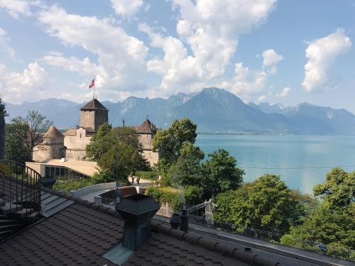 a castle with a view of the water and mountains at Castle view in Veytaux