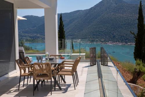 a dining room with a table and chairs on a balcony at MAJESTIC VILLAS in Yenion