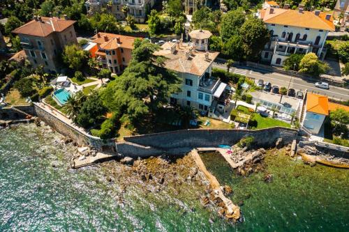 an aerial view of a house next to the water at Apartmani Belsito in Lovran