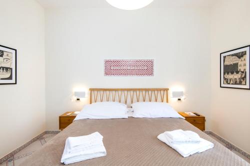 a bedroom with a bed with two white towels on it at B&B Marcantonio - Ischia Ponte in Ischia