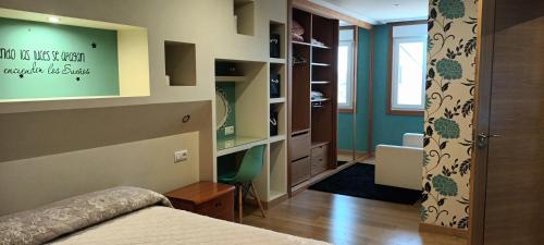 a bedroom with a bed and a room with a bathroom at Casa Pepe in Meaño