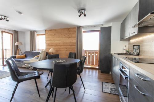 a kitchen and living room with a table and chairs at Le Bierge - Station de ski accessible à pied in Vars