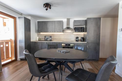 a kitchen with a table and chairs in a room at Le Bierge - Station de ski accessible à pied in Vars