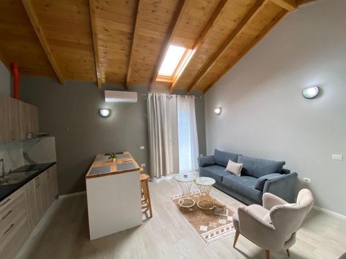 a living room with a blue couch and a table at Villa Yseni in Orikum
