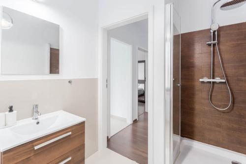 a bathroom with a sink and a shower at Chill Apartments Bociania in Warsaw