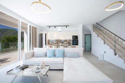 a living room with a white couch and a table at MAJESTIC VILLAS in Yenion