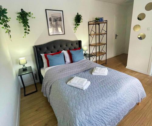 a bedroom with a large bed with two towels on it at Great Polonia River Boat Apartments Wrocław in Wrocław