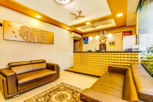 a waiting room with a couch and a bar at FabHotel Prime Sea Shore Resort in Calangute