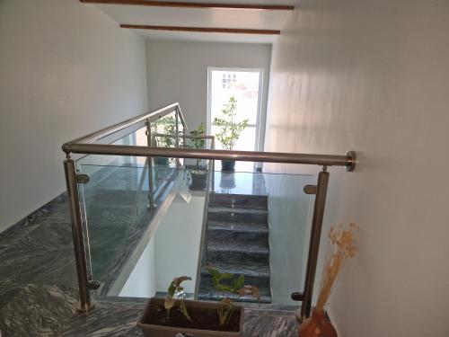 a staircase with a glass railing and a stair case at Kaps Home - Tarrafal in Tarrafal