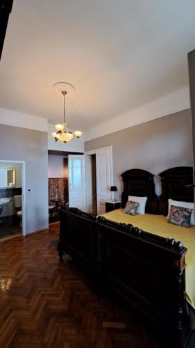 a large bedroom with a large bed and a desk at Apartmani Belsito in Lovran
