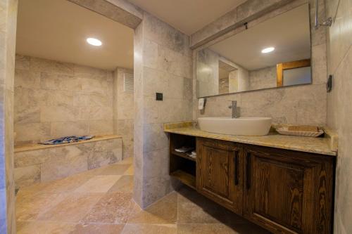 a bathroom with a sink and a mirror at Cappadocia Hobbit House in Nevşehir