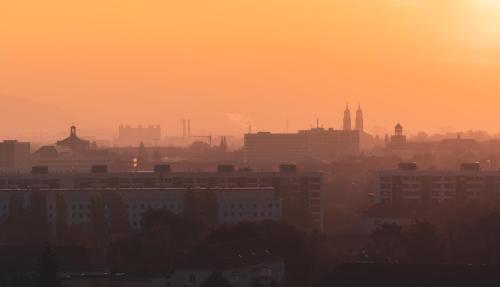a city skyline at sunset with buildings in the foreground at ACHAT Hotel Dresden Altstadt in Dresden