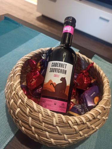 a bottle of wine in a basket of candy at Studio 43 in Belgrade