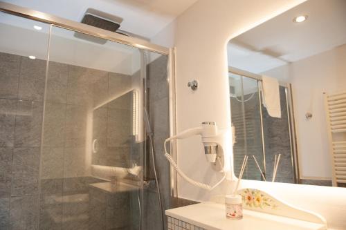 a bathroom with a shower with a phone in it at Residenza Catullo in Verona