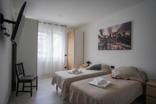 a hotel room with two beds and a window at Bnbook-Borromeo 4 Fiera Milano Rho in Rho