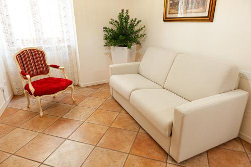 a living room with a couch and a chair at Residenza Catullo in Verona