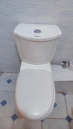 a bathroom with a white toilet in a room at Classy Spacious Studio - Waiyaki Way in Rungiri