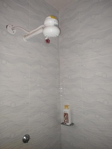 a bathroom with a shower with a light on the wall at Classy Spacious Studio - Waiyaki Way in Rungiri