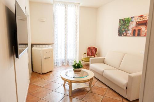 a living room with a couch and a table at Residenza Catullo in Verona