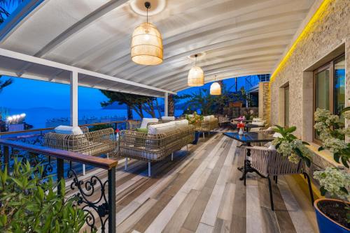 a patio with a view of the ocean at Elite Hotel Yalıkavak in Yalıkavak