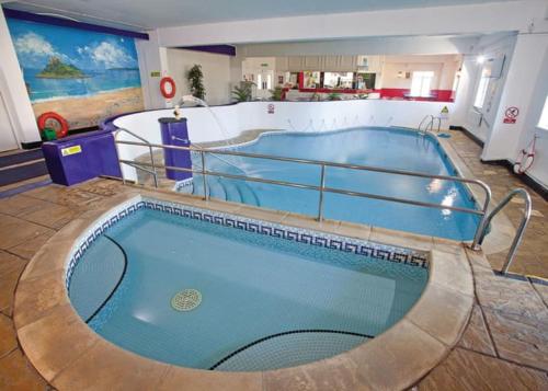 a large swimming pool in the middle of a building at Manor Court in Penzance