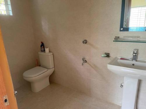 a bathroom with a toilet and a sink at Your home Away in Sylhet
