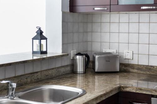 a kitchen counter with a sink and a toaster at HiGuests - Luxe Apartment With Incredible Marina Views in Dubai
