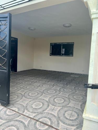 an empty room with a tile floor and a window at Casa moderna in Santiago de los Caballeros