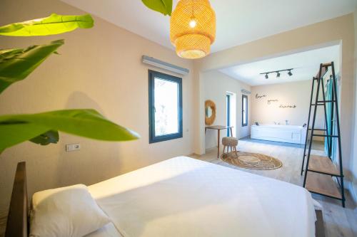 a bedroom with a white bed and a ladder at Eroğlu Villas in Fethiye